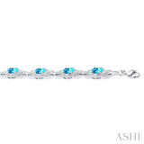 7x5 MM Oval Shape Blue Topaz and 1/10 Ctw Round Cut Diamond Semi-Precious Bracelet in Sterling Silver