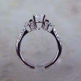 18 Karat White Gold 2 Baguettes=.14 44 Round=.41 Total Weight GHVS12 Cubic Zirconia Center