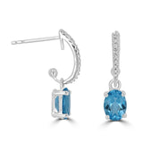 14 Karat White Gold 5X7mm Oval Blue Topaz18 Diamonds=0.08 Carat Dangle Earrings