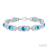 7x5 MM Oval Shape Blue Topaz and 1/10 Ctw Round Cut Diamond Semi-Precious Bracelet in Sterling Silver